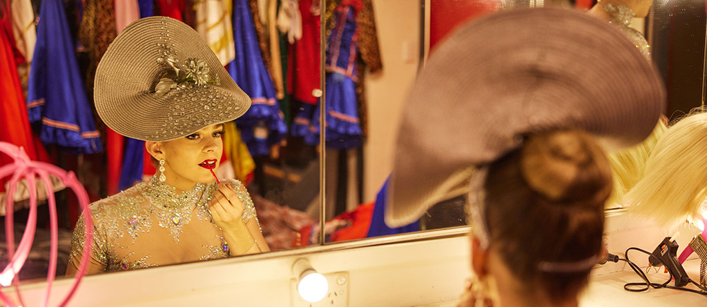 A showgirl putting on makeup and getting ready for the cabaret show